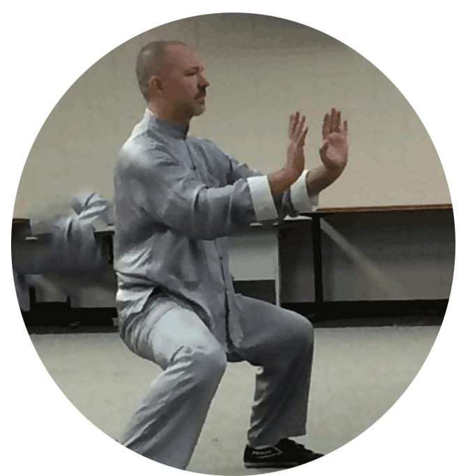 photograph of sifu gideon in a horse stance with arms pushing out